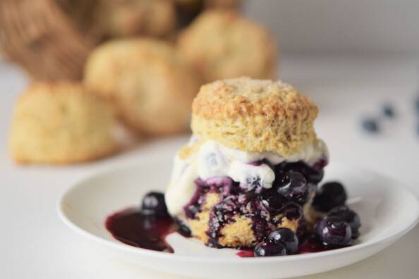 Blueberry shortcake with blueberry juice pooling on a white plate