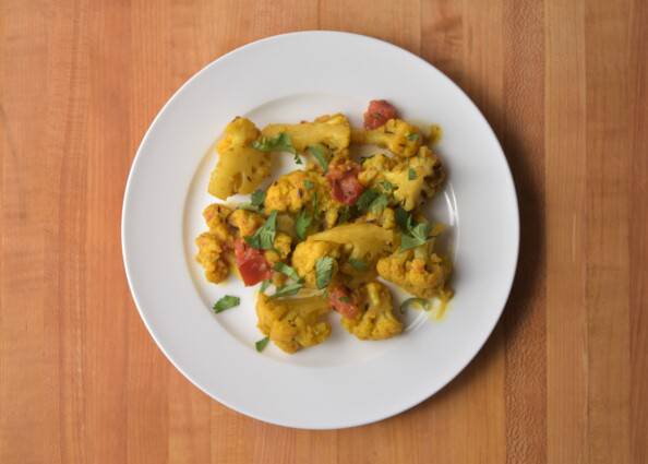 Indian spiced cauliflower overhead on a white plate