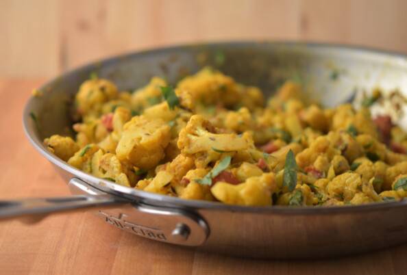 cauliflower cooked in curry spices in a skillet