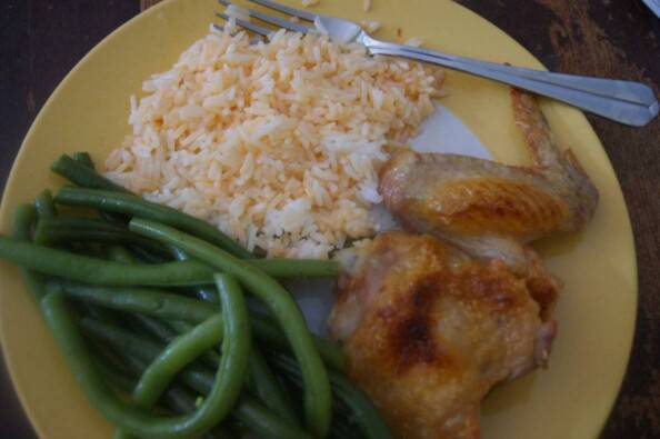 simple crispy chicken meal with green beans and hot sauce on rice