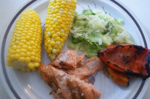 simple west coast summer meal on a plate of grilled salmon, grilled peppers, corn, and my Mother's summer cabbage recipe