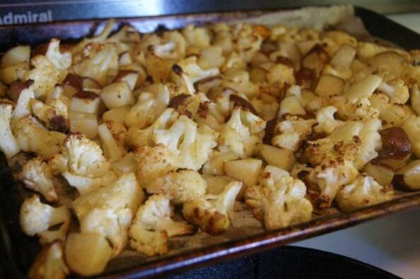 roasted cauliflower and potatoes on a pan