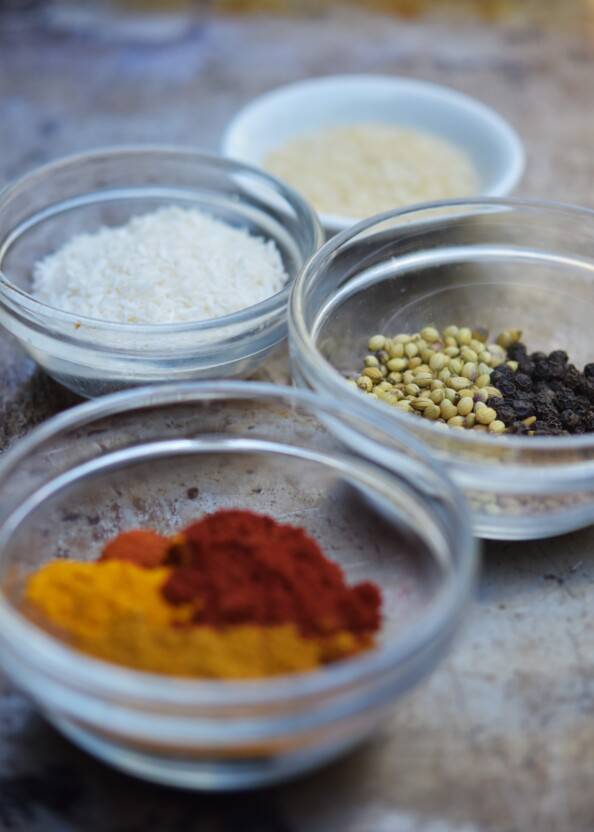 assortment of Indian spices in small glass bowls