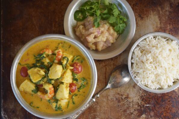 overhead of coconut curry with basmati rice and banana chutney