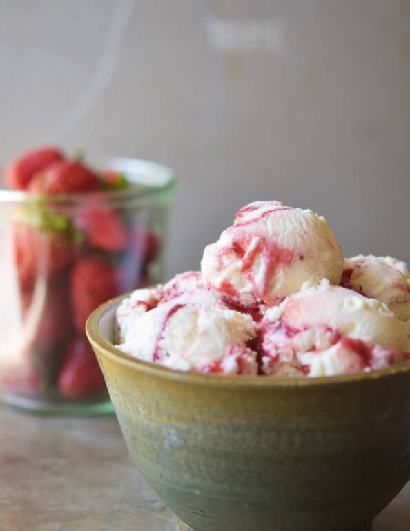 bowl of strawberry cheesecake ice cream with strawberries