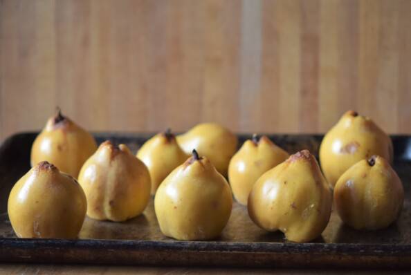 cooked whole quince on a baking sheet