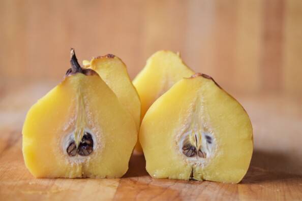 close up of quince cut in half through the core